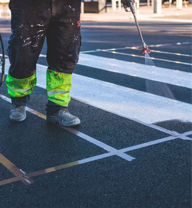 Beckage worker applying line striping