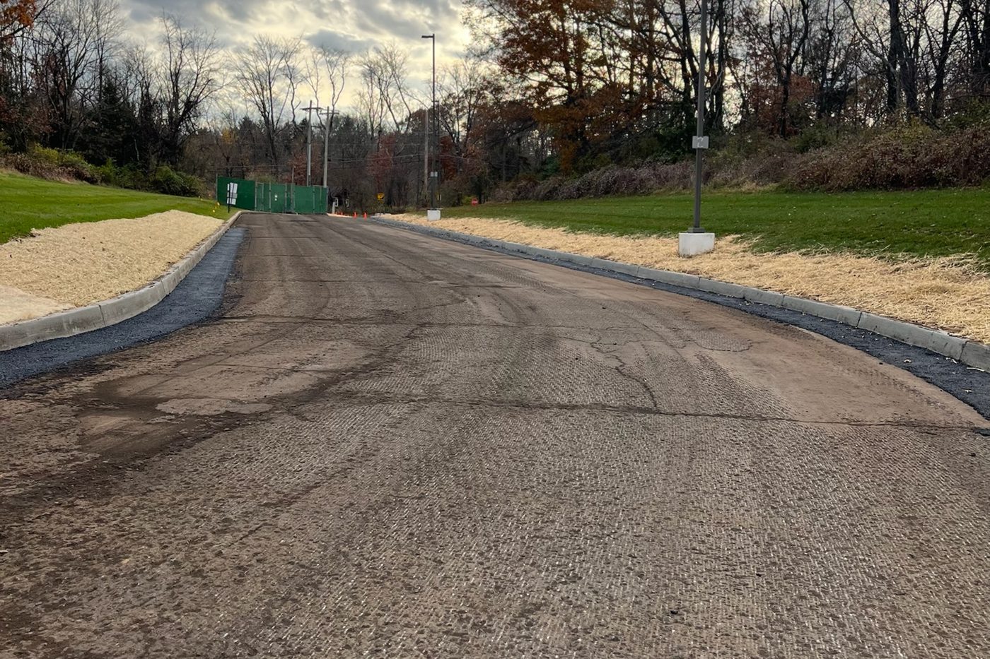 Commercial access road milled to a controlled depth, sound base left ready for a fresh asphalt wearing course in NJ