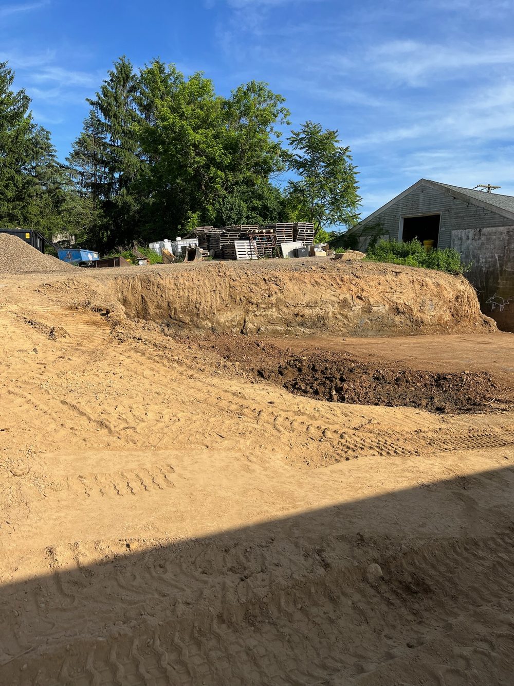 Excavated sub-grade cut down to depth on a commercial site before base and paving in NJ