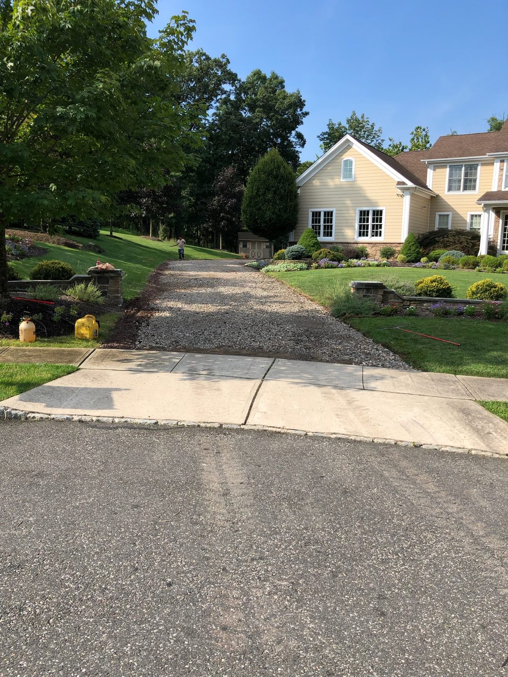 Residential driveway with a fresh quarry-process stone base graded and ready for asphalt in NJ